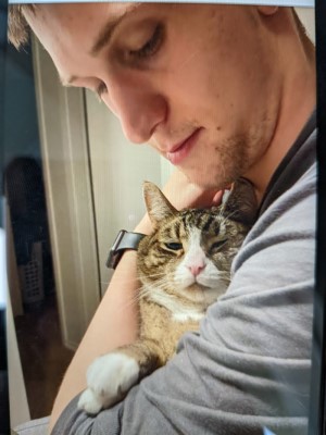 Photo of Michael Kitchener holding a cat