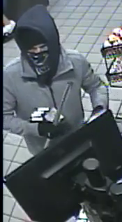 Photo of suspect with cigarettes and pipe in his hands