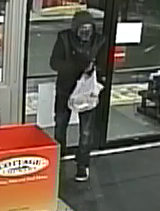 Photo of suspect with bag in his hand
