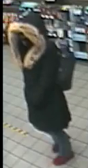 female suspect involved in the robbery - long black down-style jacket with fur trim hood