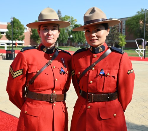 Cpl. Laura Hirst stands beside Burnaby RCMP Cpl. Freda Fong in Red Serge at Depot Division in Regina. 