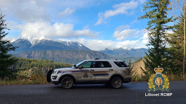 RCMP vehicle with view of clouds and Mount Noel in background