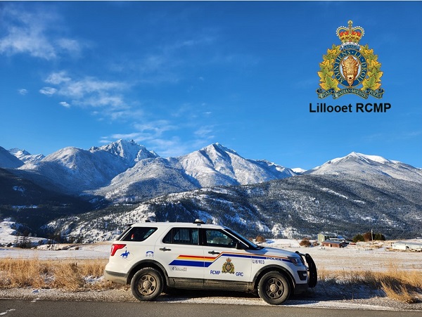 View of RCMP vehicle and mountain range in background