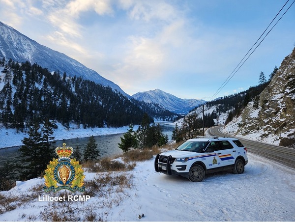 View of mountains and Hwy 12 in the background, with RCMP vehicle