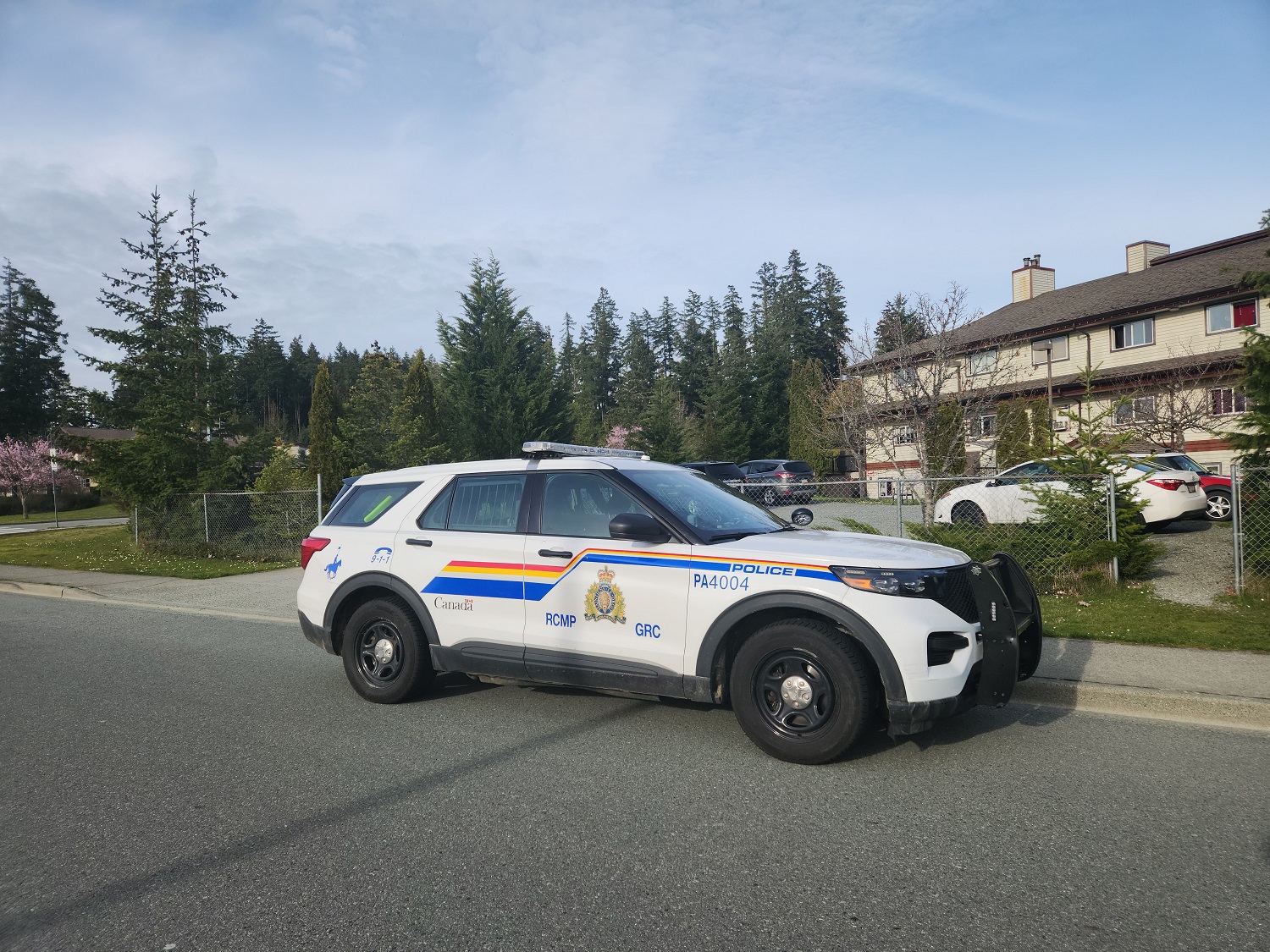 A Port Alberni police vehicle parked in front of a housing unit
