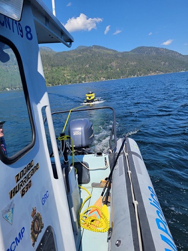 SeaDoo being towed by RCMP boat