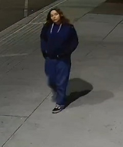 female youth suspect wearing a blue hoodie with white strings, blue jeans and black runners