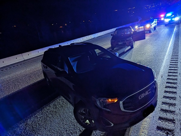 personal and police vehicles on highway 97 in the dark